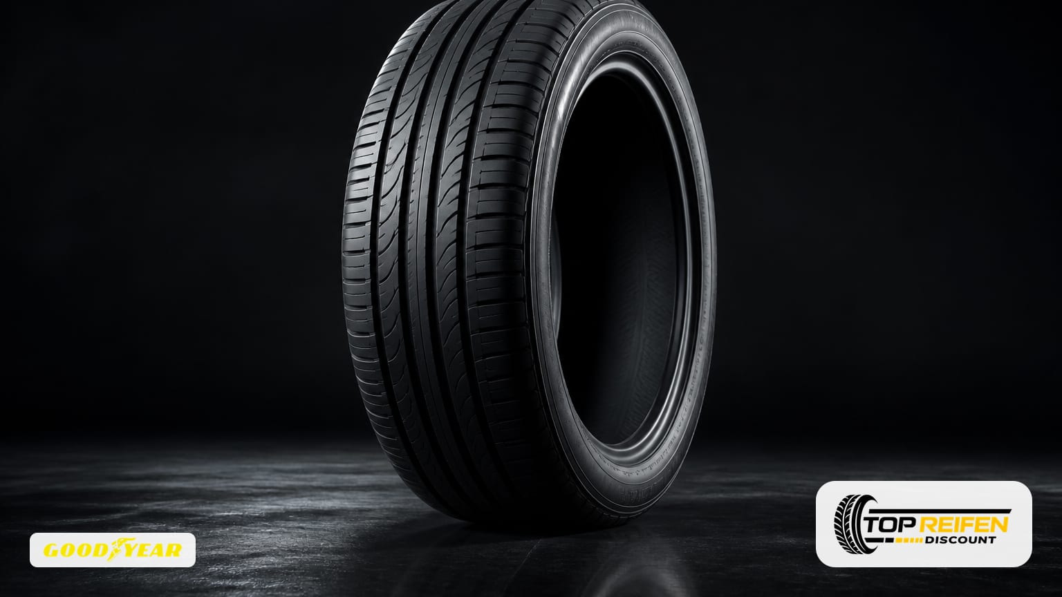 Studio still life of a single GOODYEAR EF-PE2 175/65 R17 summer tyre on a dark reflective surface with soft rim lighting.