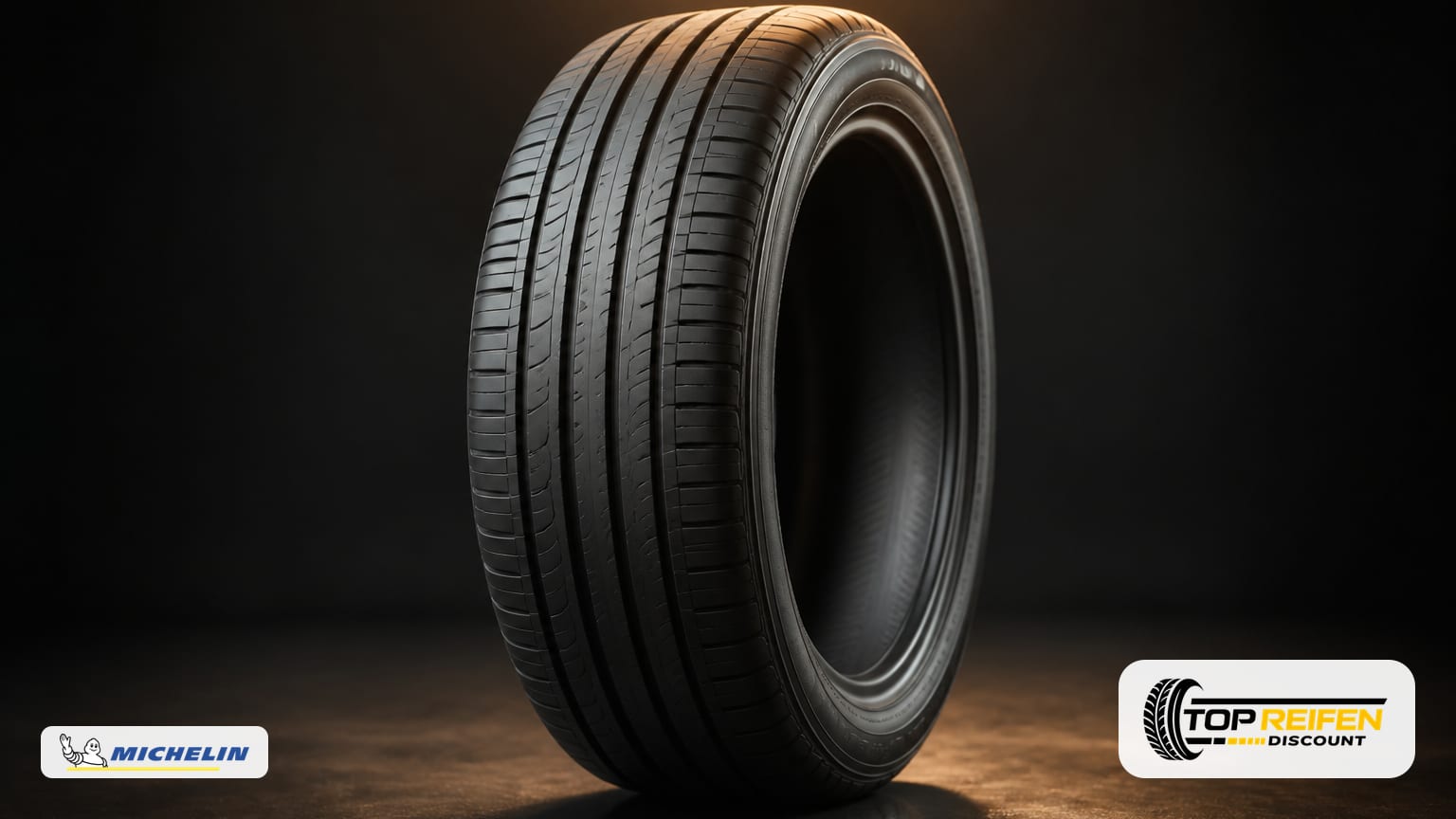 Studio still life of a MICHELIN E-PRIM 175/65 R17 summer tyre on a dark reflective surface with soft rim lighting and a minimalist backdrop.